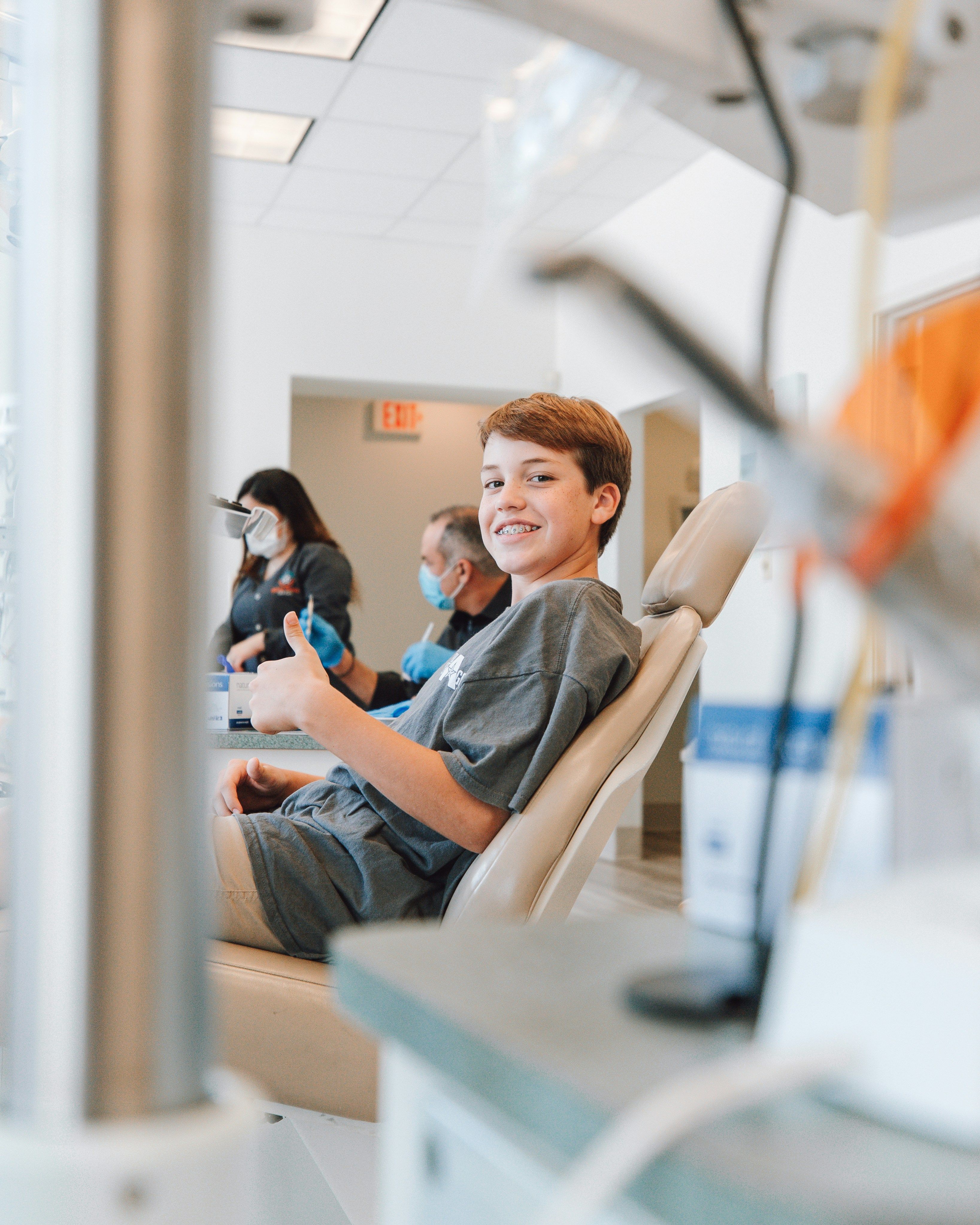 Happy child sitting in dentist' chair